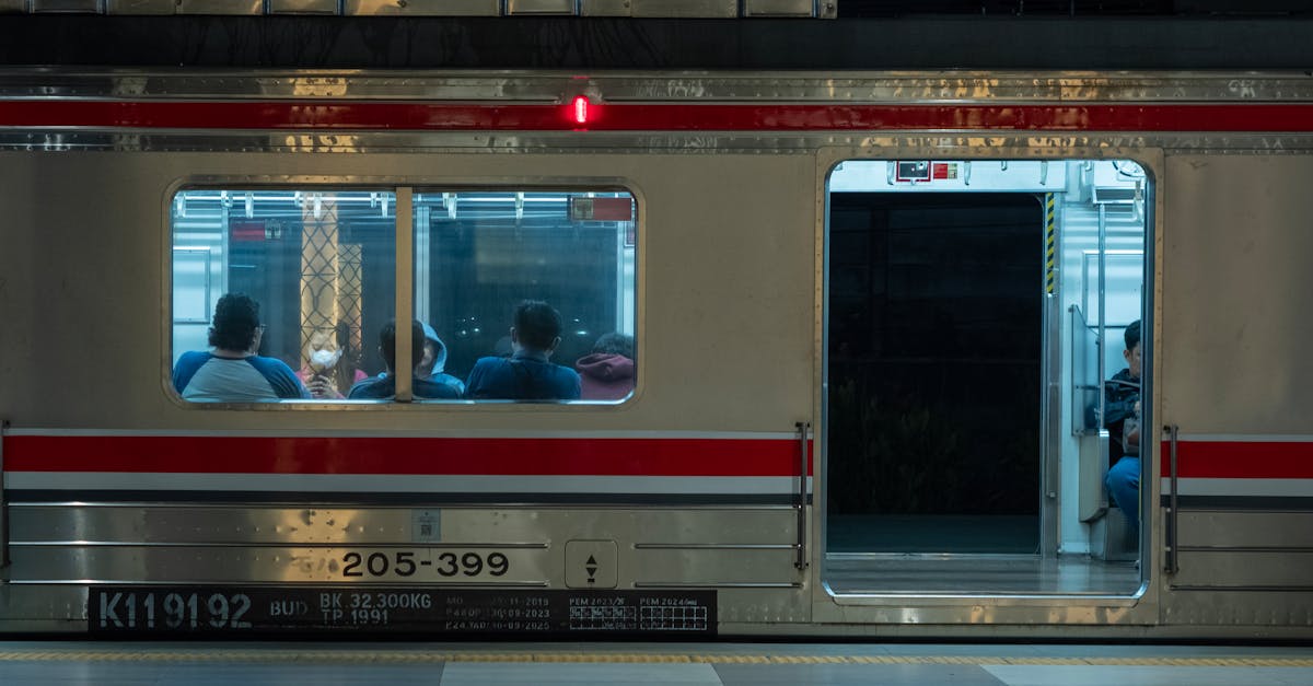 Passengers inside a train at a Jakarta station at night, capturing the city's calm vibe.