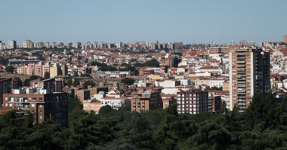 Panoramic view of urban cityscape with dense residential buildings and greenery.