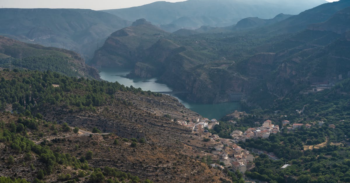 A breathtaking view of Cortes de Pallás, showcasing the valley, mountainous landscape, and serene lake.