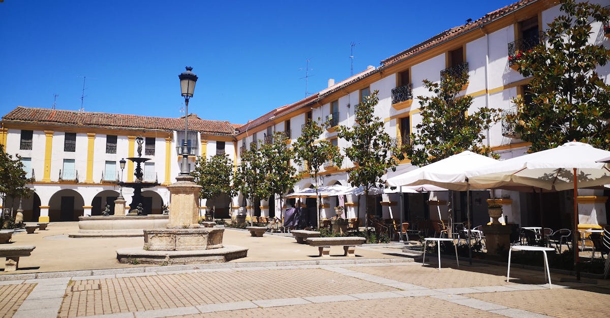 Sunny Spanish courtyard with historic architecture and outdoor cafés.