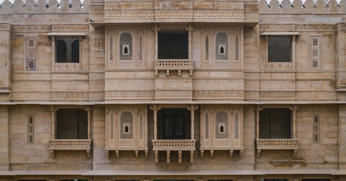 Impressive stone facade of a palace hotel in Jaisalmer, showcasing intricate architectural details.