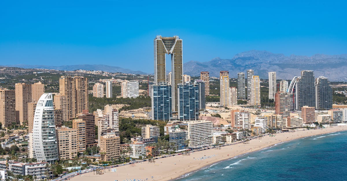 Aerial view of Benidorm's beachfront with iconic Intempo building.