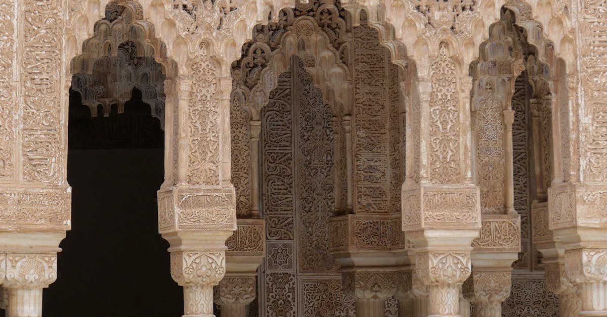 Detailed view of ornate Moorish arches at the historic Alhambra Palace in Granada, Spain.