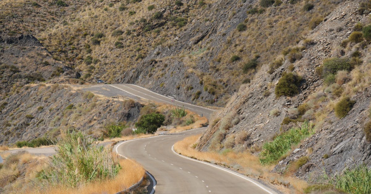 Scenic view of a winding road through arid mountains, ideal for adventure seekers.