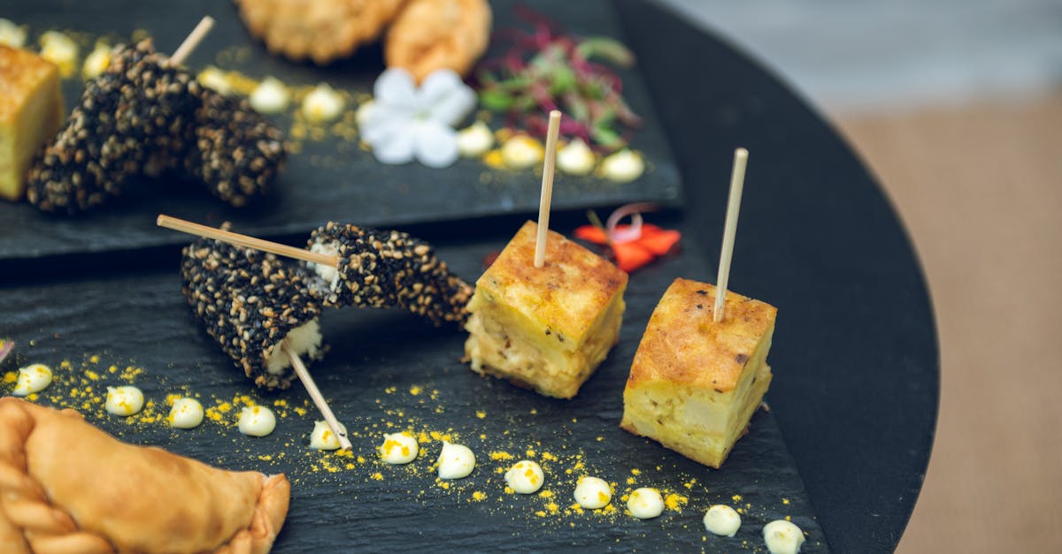 Savour Argentinian tapas with empanadas and fernet snacks beautifully presented on a slate platter. Ideal for outdoor brunching or evening drinks.