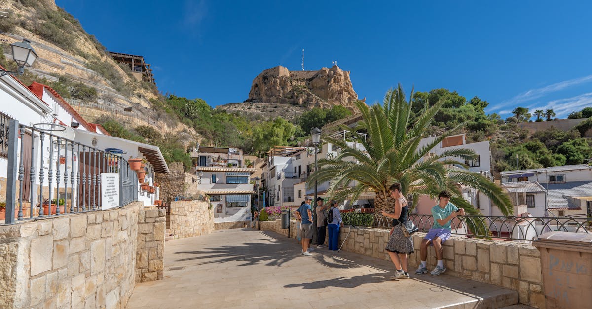 A beautiful sunny day in Alicante, showcasing Santa Bárbara Castle and local architecture.