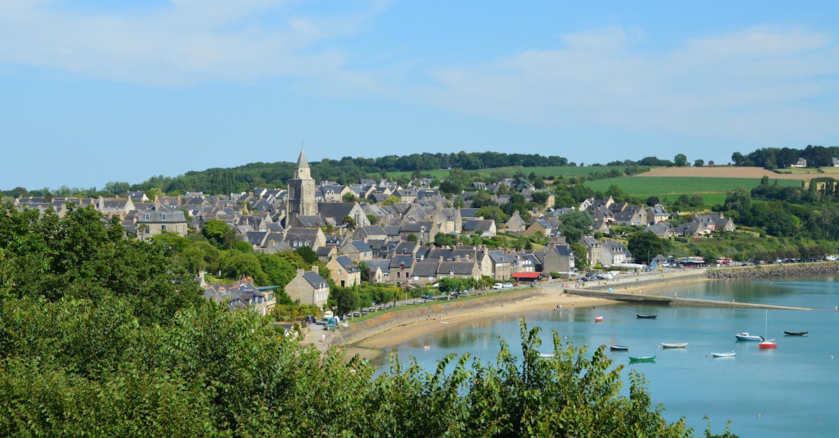 Charming coastal village landscape of Saint-Suliac in Brittany, France, with serene waterfront and greenery.