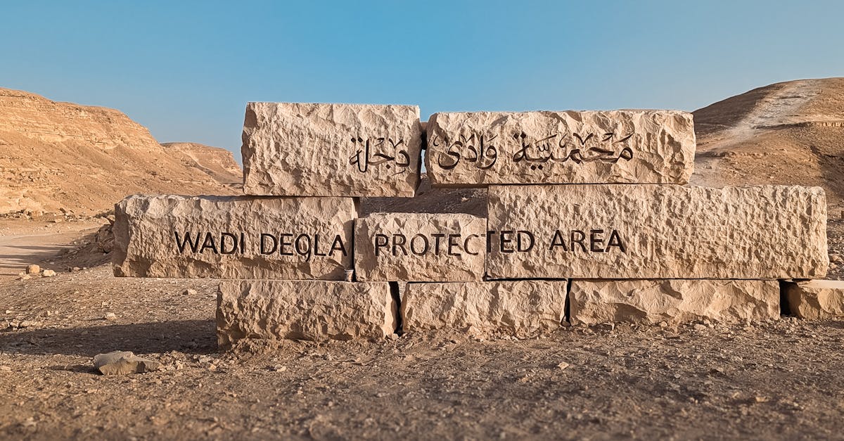 Stone sign marking the entrance to Wadi Degla Protected Area in Egypt's desert landscape.