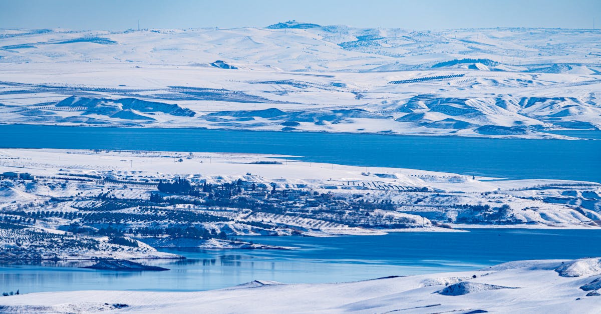 Breathtaking winter landscape of snow-covered hills and water in Adıyaman, Türkiye.