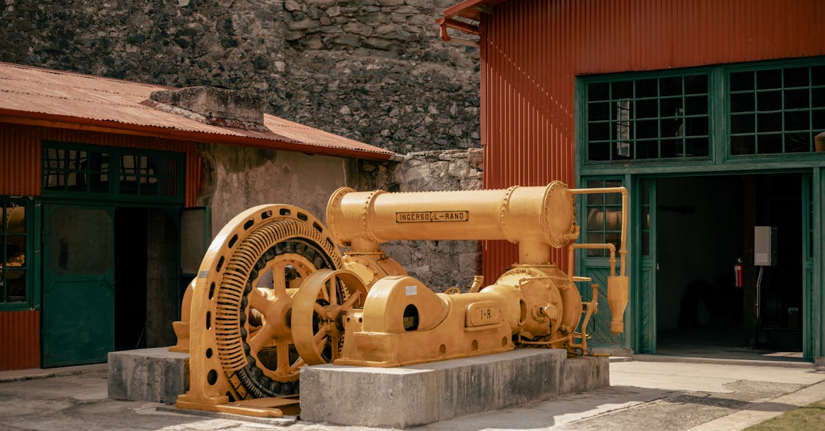 Old mining machinery showcased outdoors at a Mexican museum.