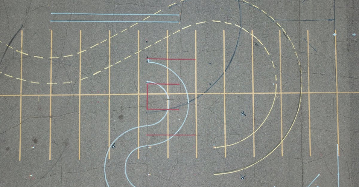A top-down shot of colorful abstract road markings on worn asphalt.