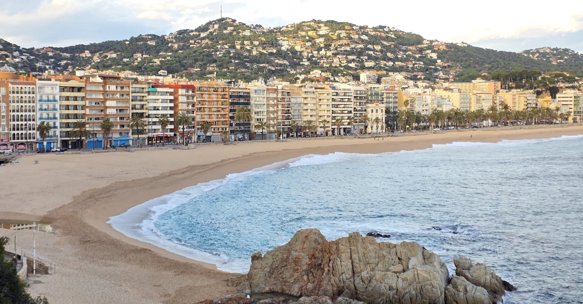 A picturesque view of Lloret de Mar beach with warm sands and vibrant buildings.