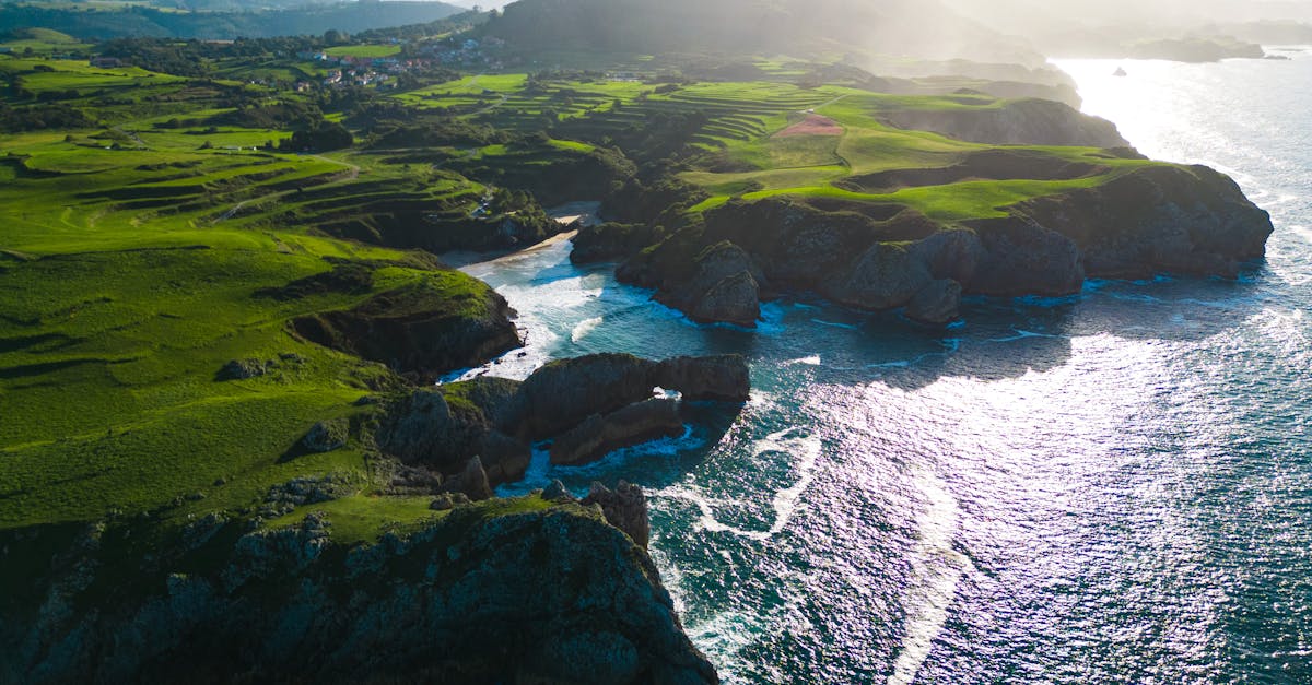 A breathtaking aerial shot of the rugged coastline and lush green landscape of Asturias, Spain.