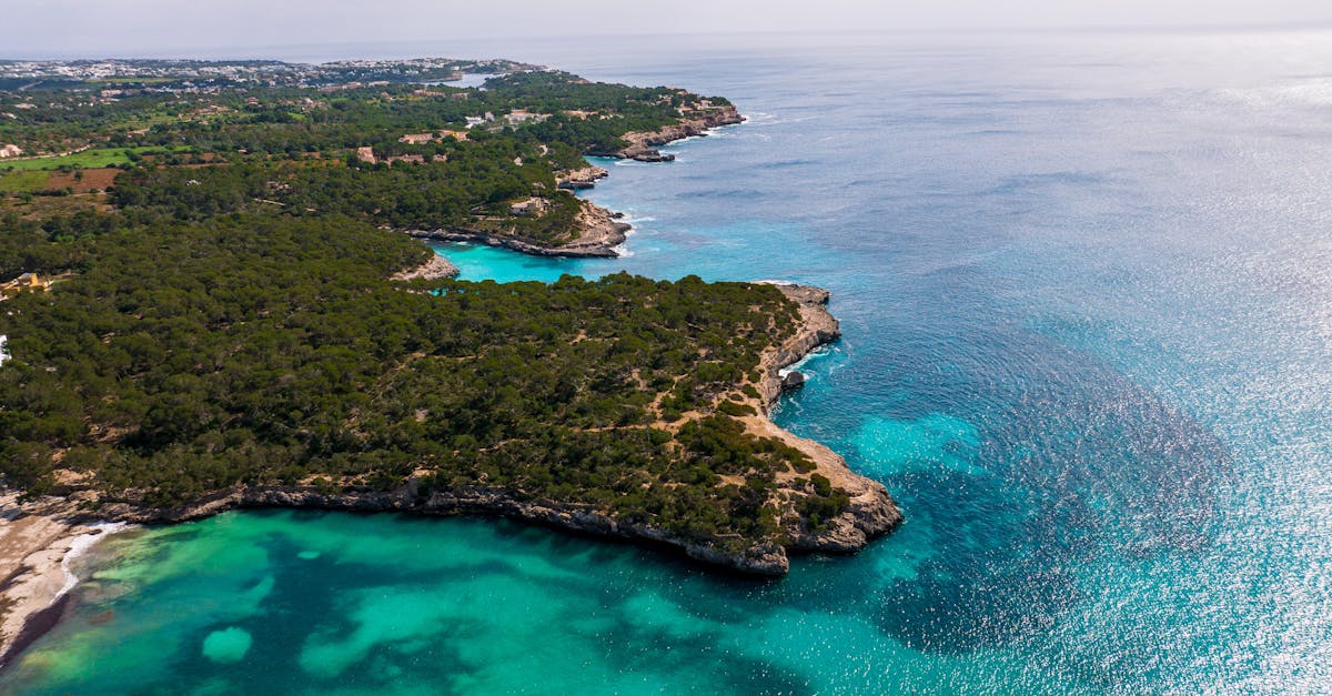 Breathtaking aerial shot of Mallorca's turquoise waters and rugged coastline in Islas Baleares, Spain.