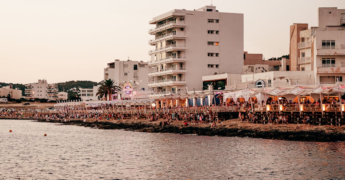 Lively Ibiza waterfront scene showcasing vibrant coastal nightlife at sunset.