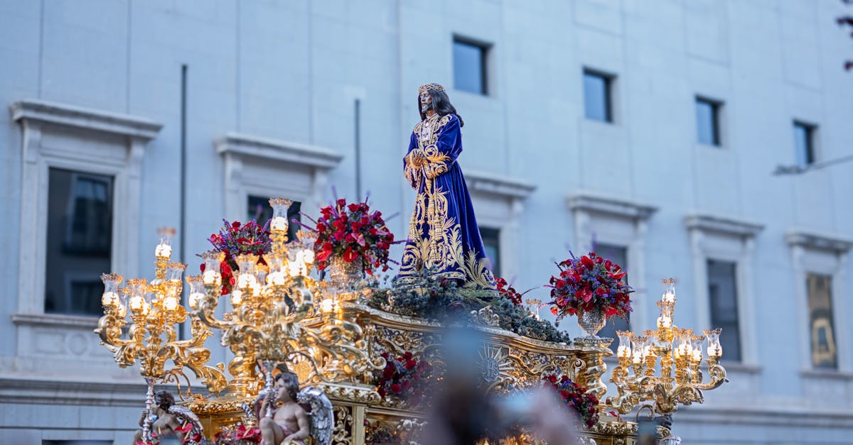 Vibrant Holy Week procession featuring an ornate religious float, in Madrid, Spain.