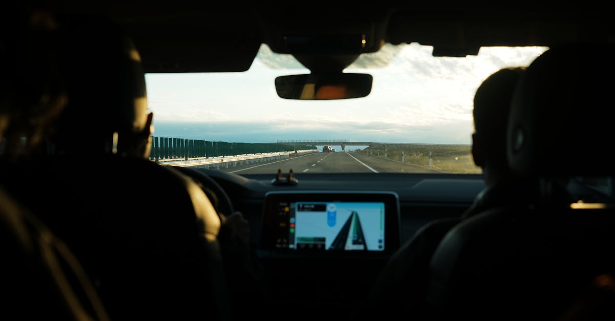 View from inside a car during a road trip showcasing an open highway and digital navigation screen.