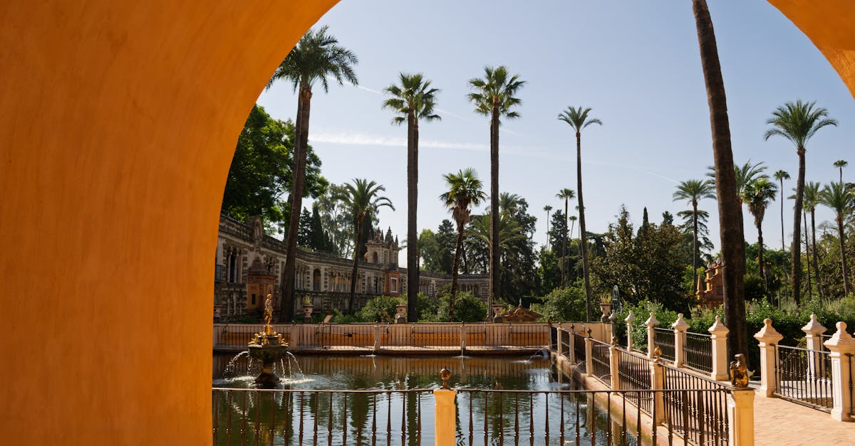Captivating view of gardens and water feature at Real Alcázar in Seville, Spain.