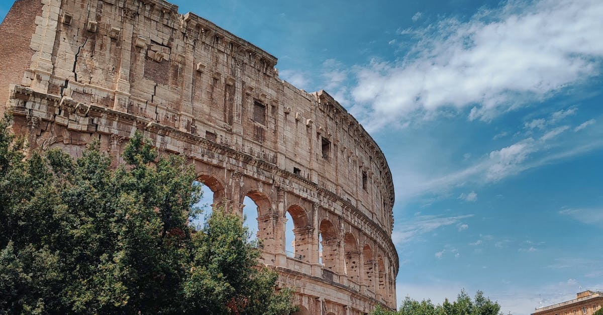 Iconic Roman Colosseum against a clear sky. Perfect for travel and history themes.