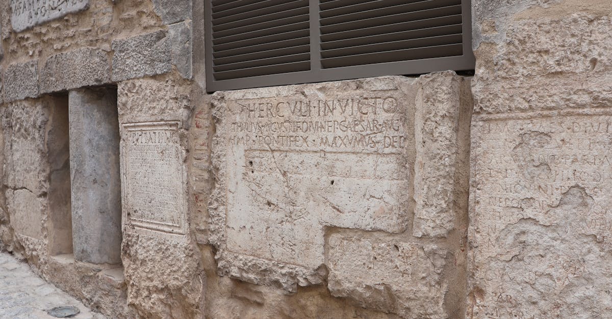Historic stone wall with ancient inscriptions in Martos, Andalucía, Spain.