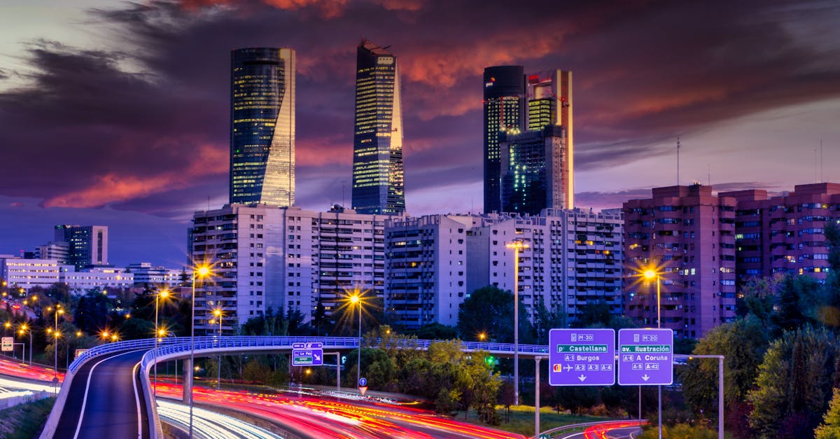 Stunning Madrid skyline captured at dusk with dynamic light trails and iconic skyscrapers.