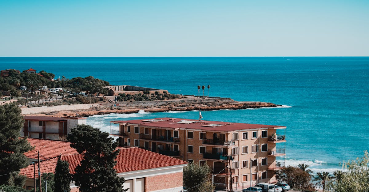 Aerial view of Tarragona's stunning coastline with clear blue skies and Mediterranean Sea.