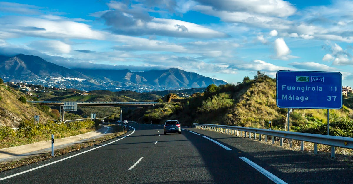 Beautiful view of AP-7 highway near Fuengirola and Málaga, with distant mountains under a blue sky.