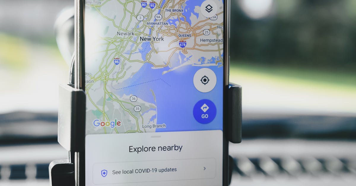 A smartphone displaying GPS map of New York City secured in a car mount during daylight.