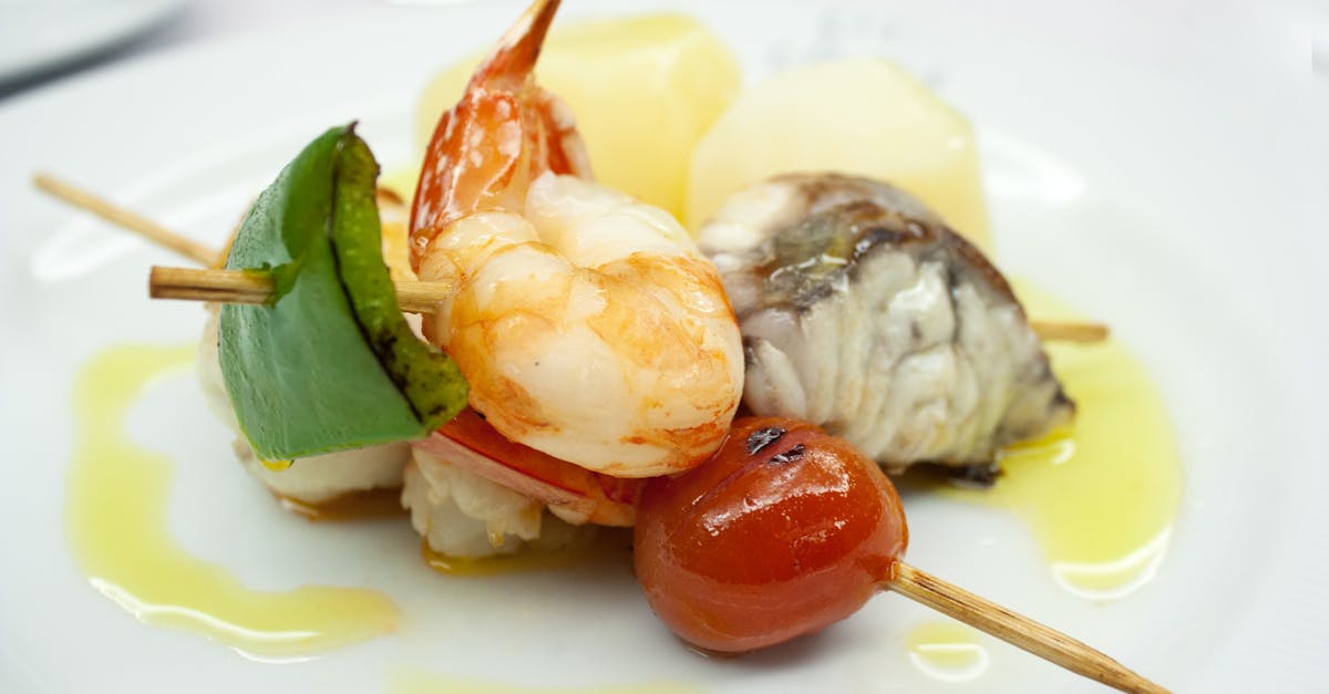 Delicious seafood skewer with prawns, fish, and vegetables drizzled with olive oil.