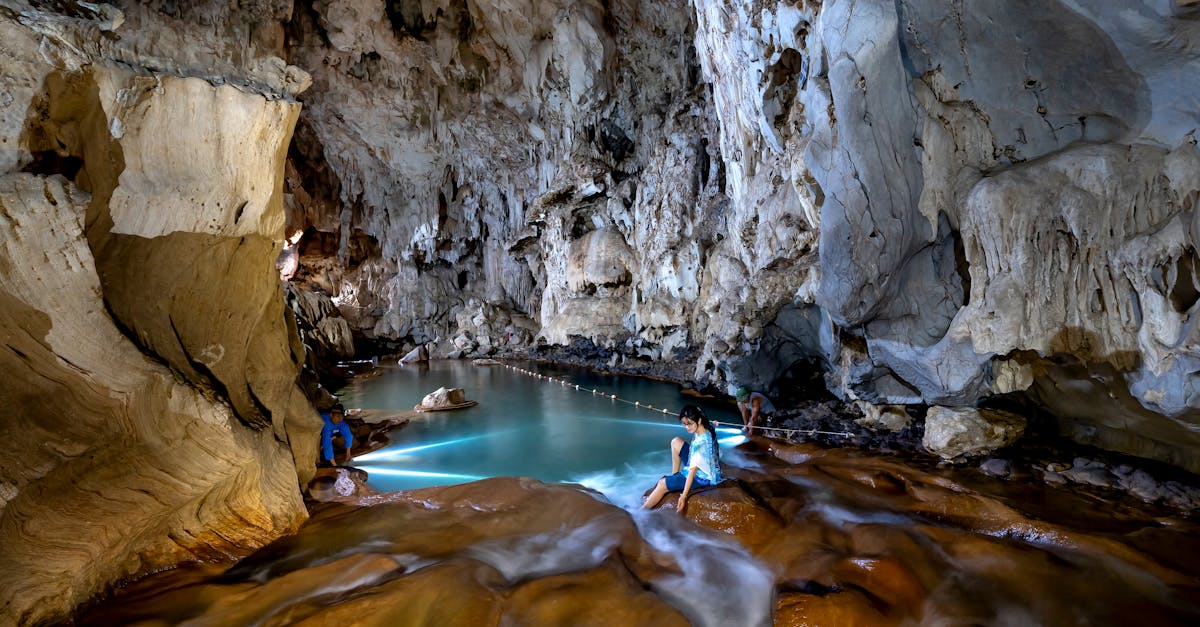 Explore a serene cave with a natural pool and captivating rock formations.