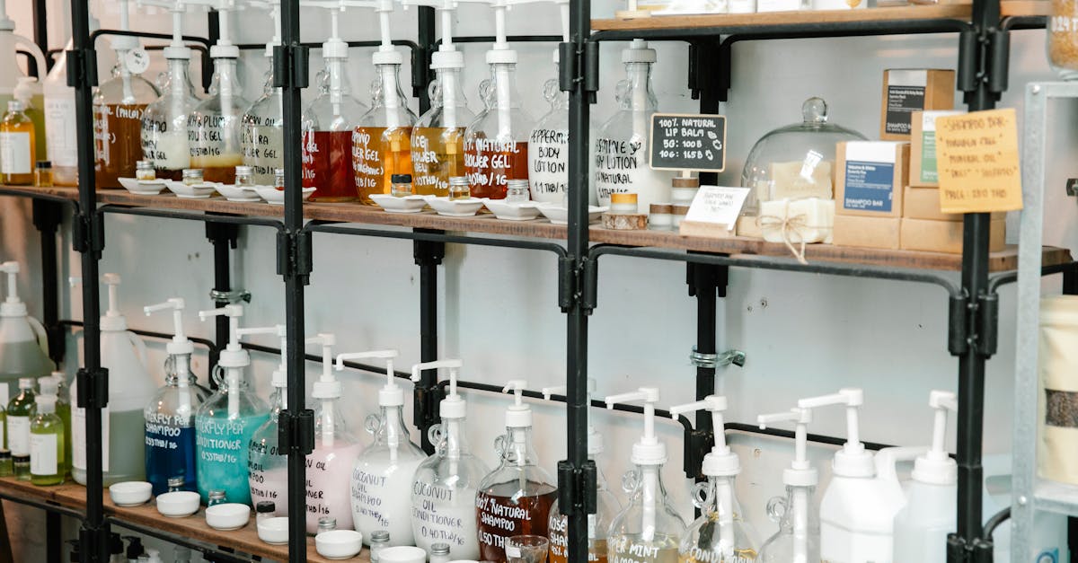 Collection of different plastic bottles with multicolored soap placed on shelves in zero waste shop