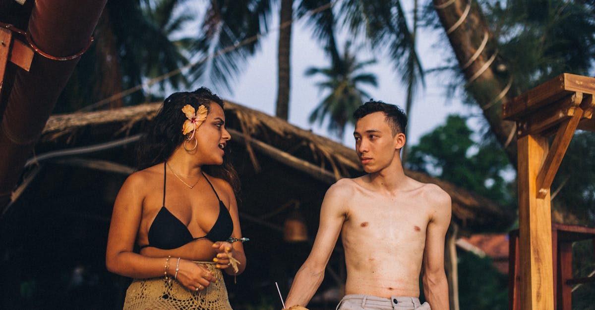 A lively young couple enjoying a tropical retreat at a beachside location.