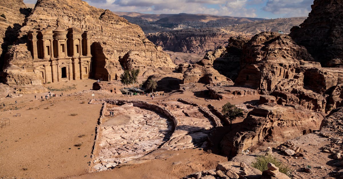 Explore the stunning Ad Deir Monastery in Petra, Jordan, surrounded by rugged desert landscapes.