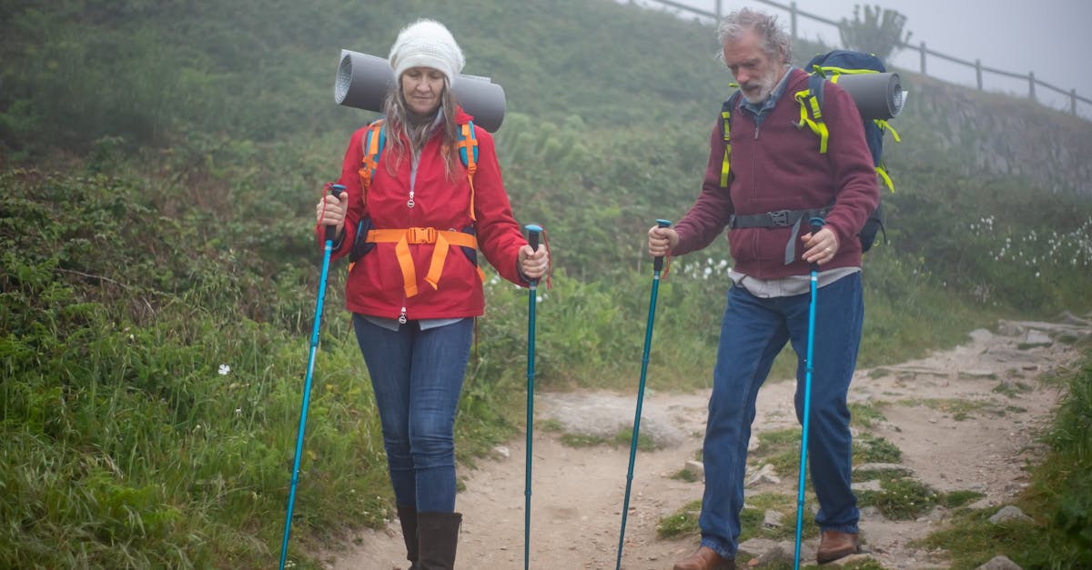 Elderly couple hiking on a foggy trail in Portugal, enjoying nature and adventure.