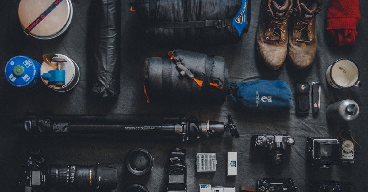 Flat lay of outdoor camping and photography equipment neatly organized.