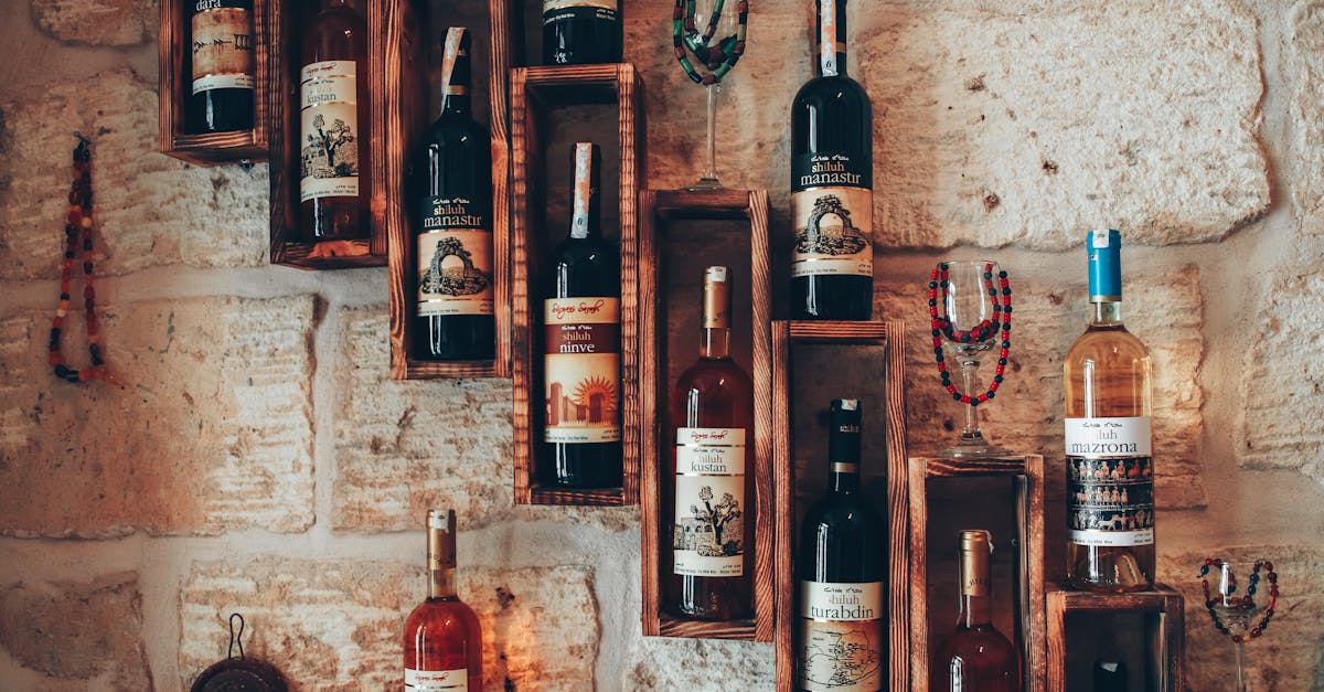 Aesthetic arrangement of wine bottles on rustic wooden shelves against a stone wall, conveying a classic vintage feel.