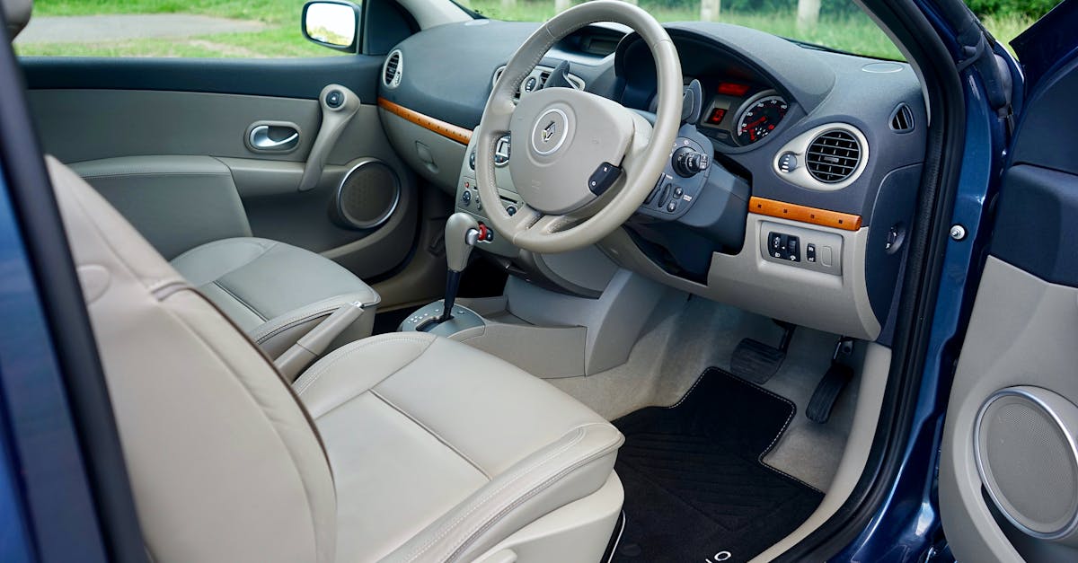 Explore the detailed view of a car interior featuring a modern steering wheel and dashboard.