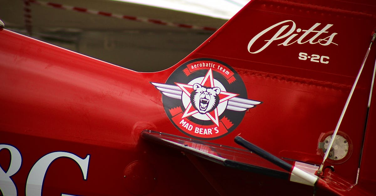 Red aerobatic plane with Mad Bear's logo parked at Krasnodar airfield.