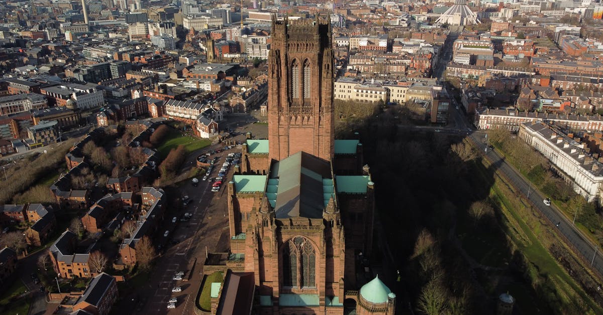 Drone shot capturing the iconic Liverpool Cathedral and surrounding cityscape.